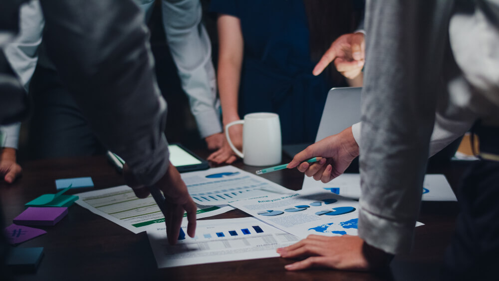 A group of business people looking at graphs on a table