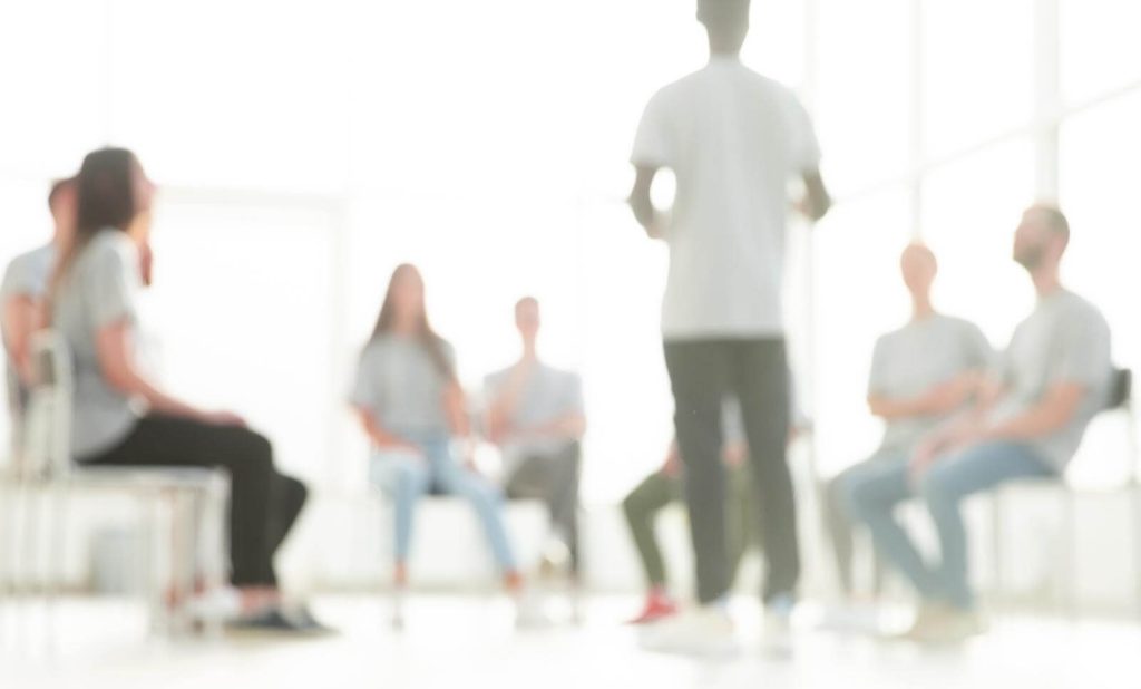 A group of people sitting in chairs in a room