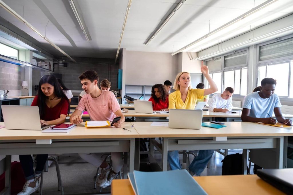 A group of students in a classroom with laptops