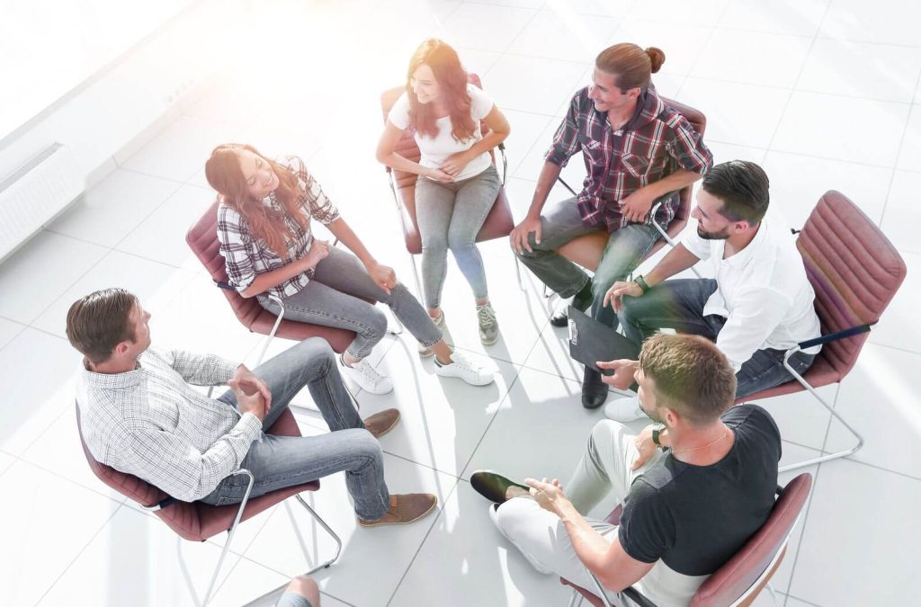 A group of people sitting in chairs